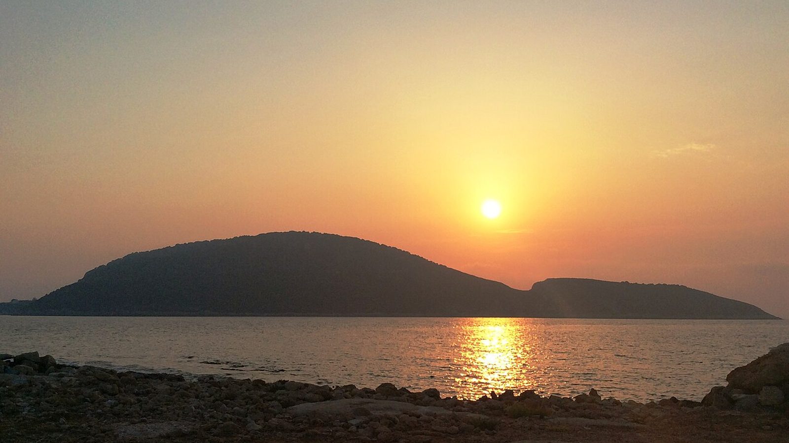 Sunset over Proti islet off Marathopoli