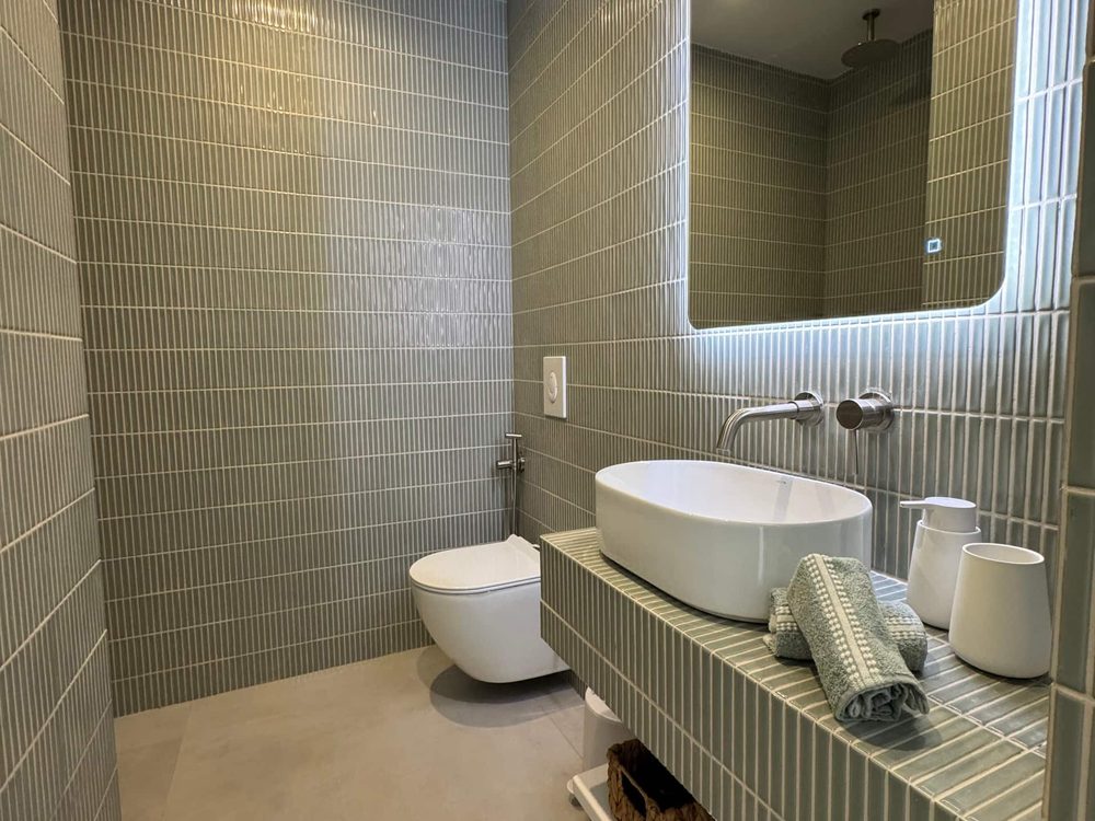 Sage green bathroom at House II