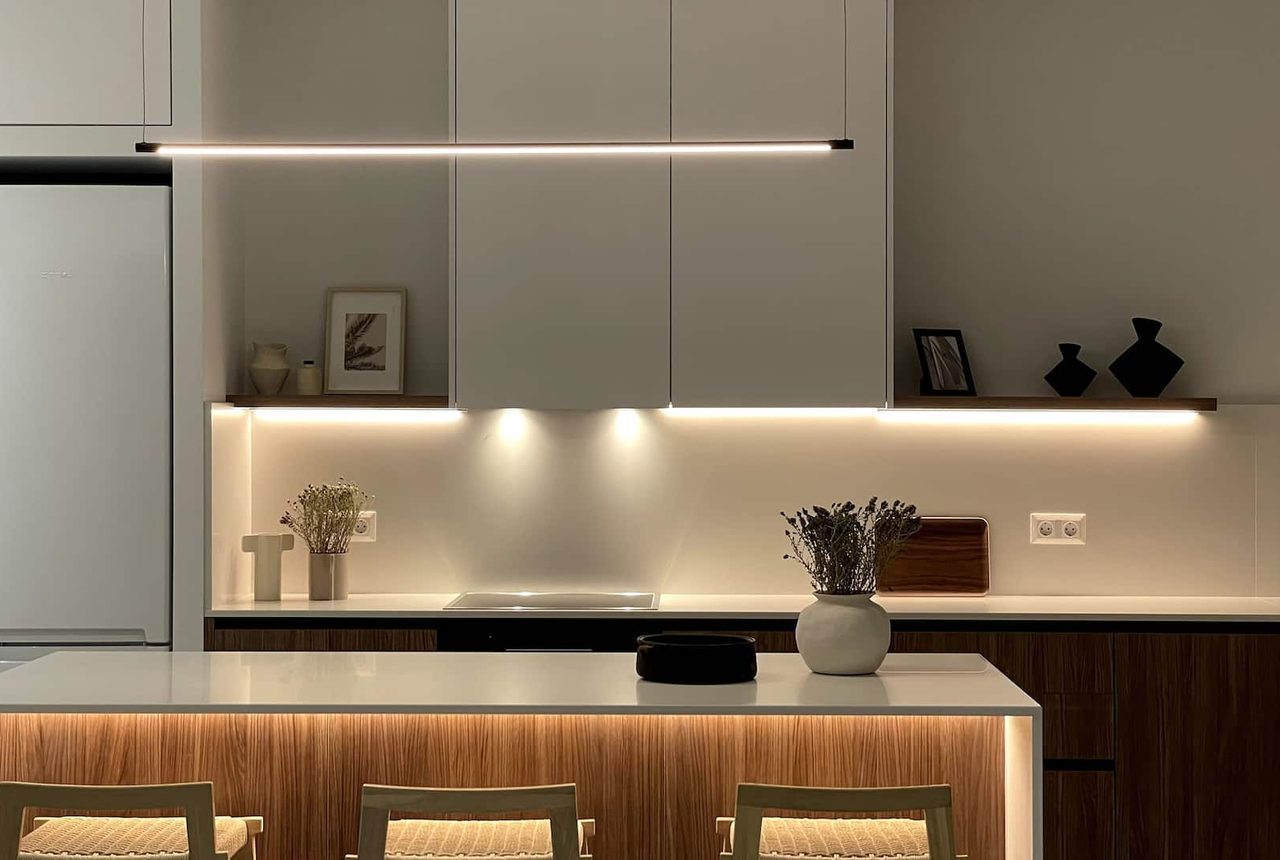 Modern kitchen with wood cabinetry and breakfast bar at Beach House I
