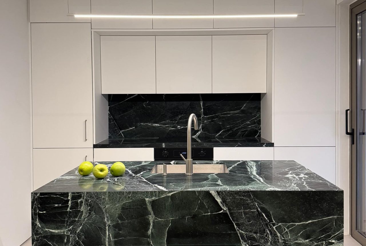 Dramatic black-marble kitchen island at Beach House II